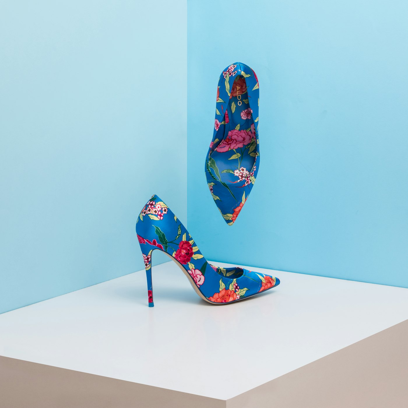 Display shelf of heels, wedges and boots in coordinated tones